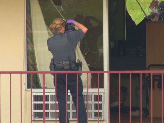 Holes left in the window after SWAT deployed tear gas.