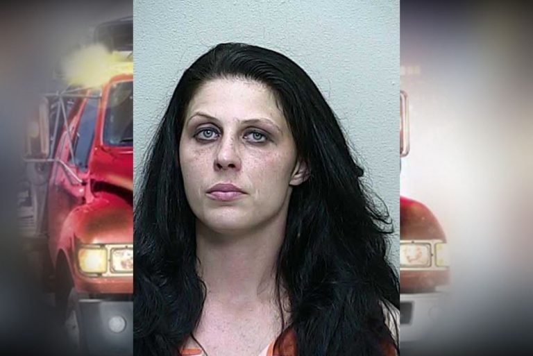 Woman tried to drive off with car attached to tow truck
