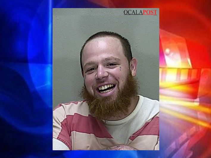 Attempted murder suspect smiles for his booking photo