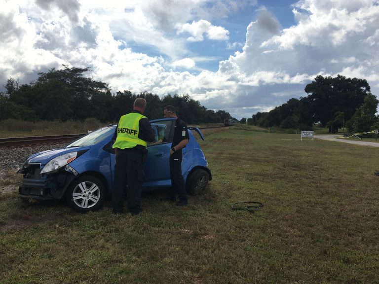 Man dies after vehicle hit by train