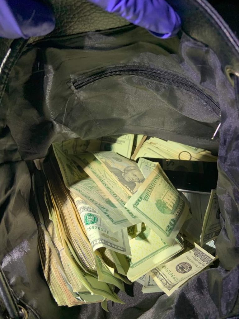 Police discover bag full of cash and drugs, searching for owner